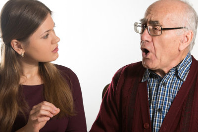 healthcare staff helping senior man to speak clearly