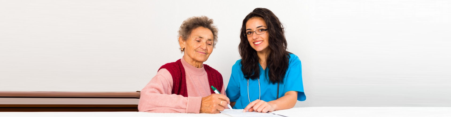 healthcare staff and the senior woman writing