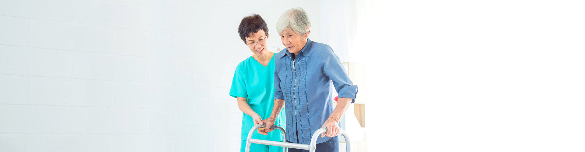 healthcare staff helping senior woman to walk