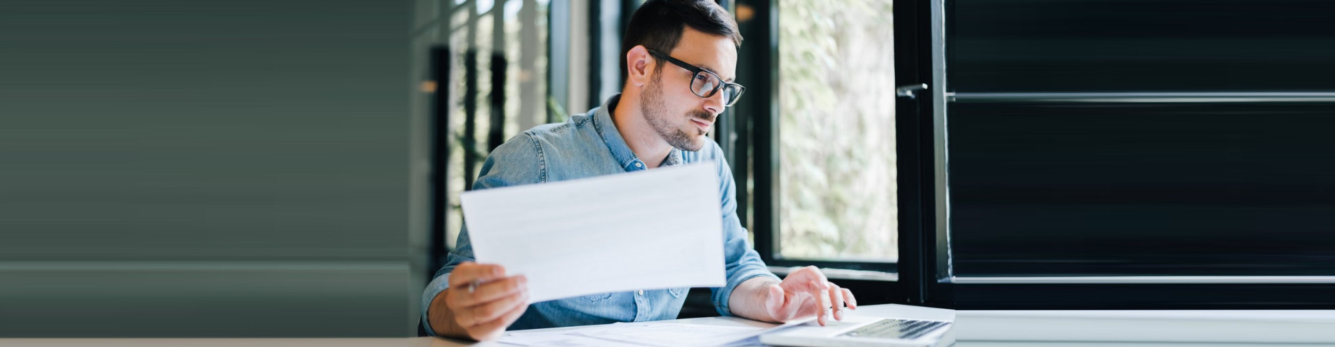 image of a man holding a paper